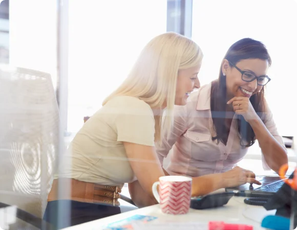 Two girls working on computer