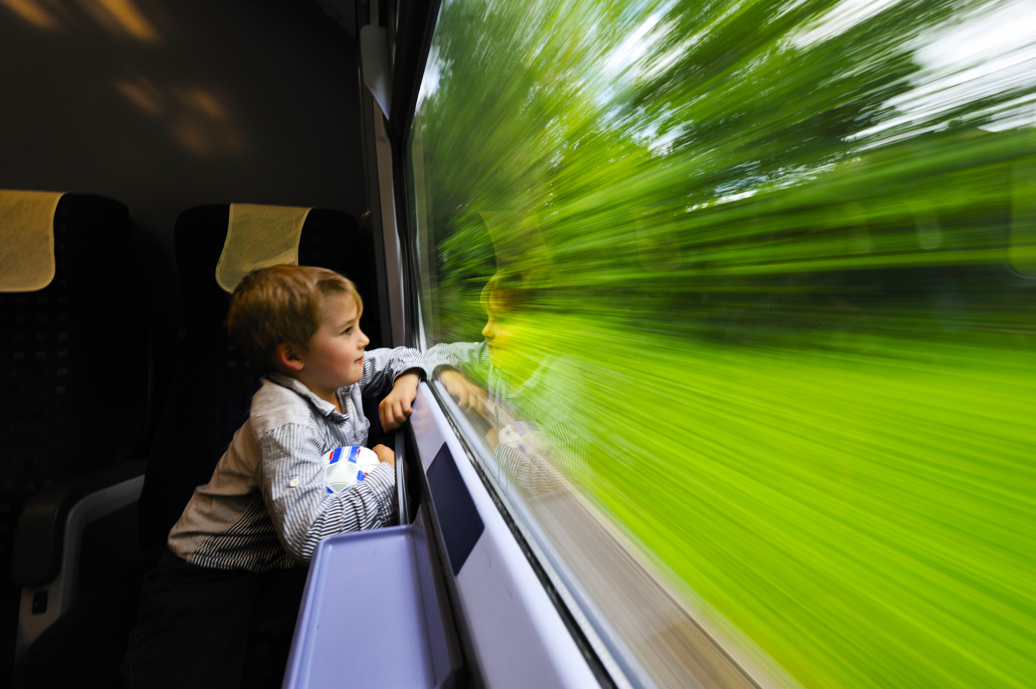 Boy looking out of train window